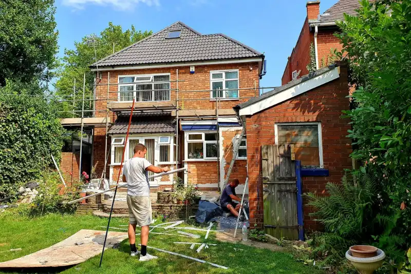 RJ Ocall Rendering team preparing the back of a house for rendering, with scaffolding up